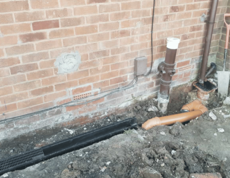 groundworks of exterior drains outside a property