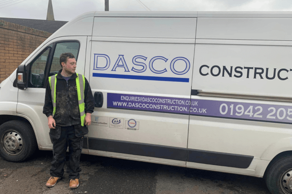 a person standing in front of a Dasco Construction van