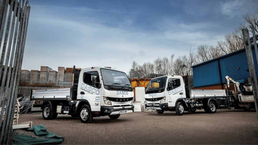 Two of Dasco Construction's new FUSO Canter trucks facing each other