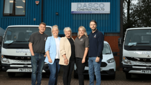 Team DASCO with Wigan Business Awards organisers smiling in front of their premises in Wigan