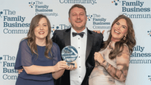 Charlotte Rothwell, Scott Rothwell, and Jessica Payne celebrate receiving the Construction, Property Maintenance and Engineering award