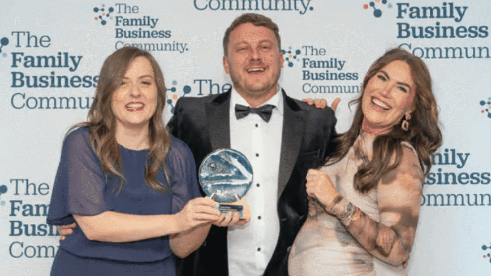 Charlotte Rothwell, Scott Rothwell, and Jessica Payne celebrate receiving the Construction, Property Maintenance and Engineering award
