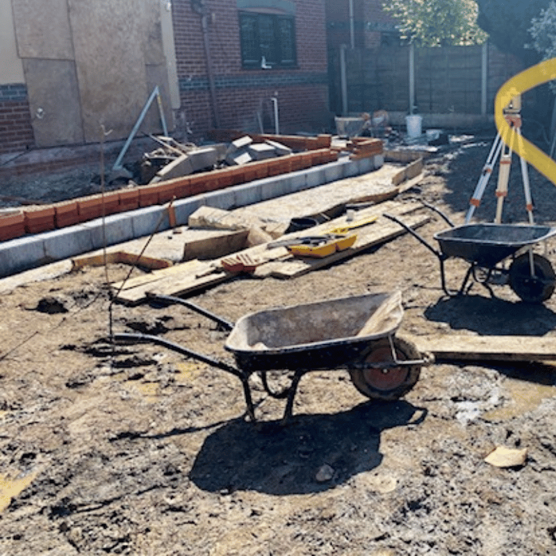 Worsley extension with a wheel barrow on a building site